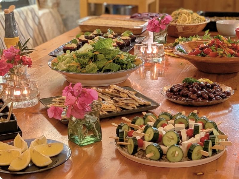 Shared meal table with fresh dishes and simple local food during a retreat at YogaOnCrete