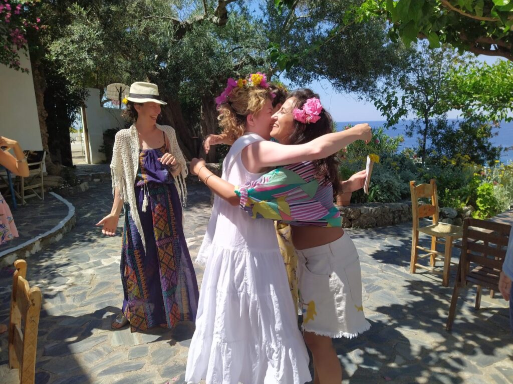 guests sharing a joyful moment during a yoga retreat in Crete