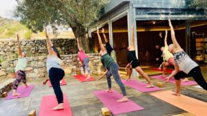 Guests sharing a meal during a small-group yoga retreat in Crete, Greece